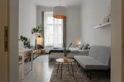 a living room with a couch and a table at Cozy warm studio in Prague city center in Prague