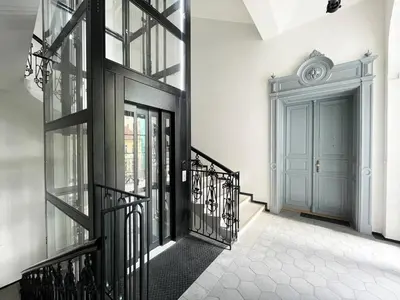a hallway with a blue door and a staircase at Vintage & Modern - best of both worlds in the heart of Prague in Prague