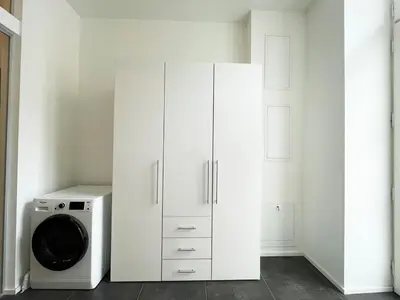 a white kitchen with a washing machine and a microwave at Vintage & Modern - best of both worlds in the heart of Prague in Prague
