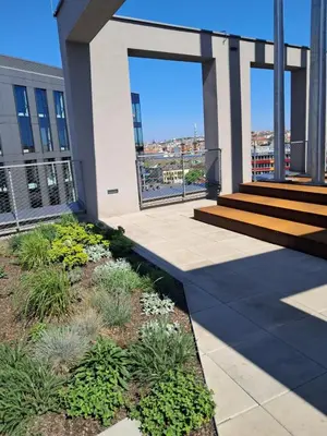 a building with a patio with plants on it at Modern flat with Rooftop Terrace in Prague