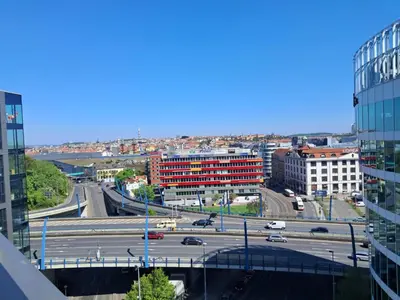 a view of a city with a highway and buildings at Modern flat with Rooftop Terrace in Prague
