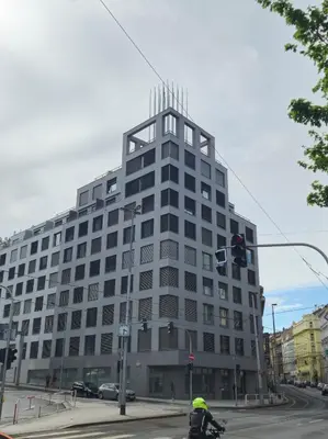 a man riding a bike in front of a building at Modern flat with Rooftop Terrace in Prague