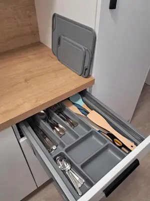 an open drawer in a kitchen with tools at Modern flat with Rooftop Terrace in Prague