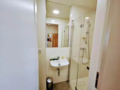 a white bathroom with a sink and a shower at TERRACE-VIEW PRAGUE STUDIOS for Business & Leisure, FREE PARKING, Near Metro, Gym in Prague