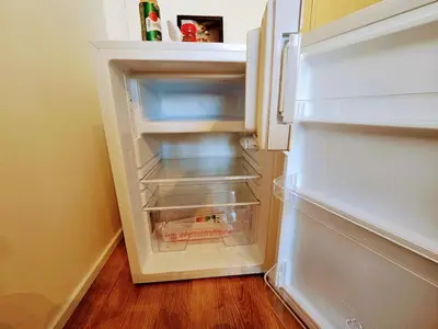 an empty refrigerator with its door open in a kitchen at TERRACE-VIEW PRAGUE STUDIOS for Business & Leisure, FREE PARKING, Near Metro, Gym in Prague