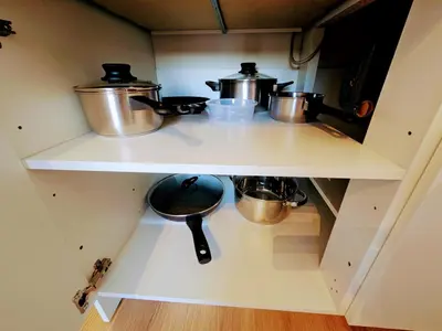 a kitchen with two pots and pans on a shelf at TERRACE-VIEW PRAGUE STUDIOS for Business & Leisure, FREE PARKING, Near Metro, Gym in Prague