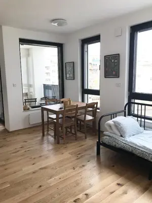 a room with a table and chairs and a dining room at Apartmantplus01 in Prague