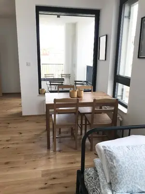 a dining room with a wooden table and chairs at Apartmantplus01 in Prague