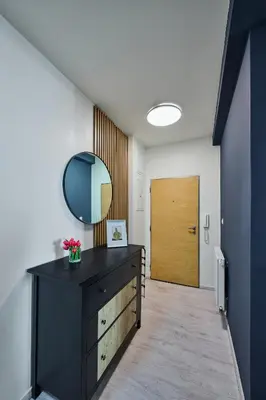 a room with a dresser with a mirror and a door at Apartment Mostecka in Prague