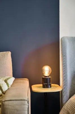 a small table with a candle on it next to a couch at Apartment Mostecka in Prague