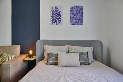 a bedroom with a bed and a couch and a picture at Apartment Mostecka in Prague