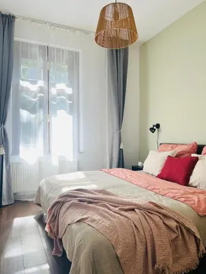 a bedroom with a large bed and a window at Quiet and Cozy Apartment by the Walls of Vyšehrad in Prague