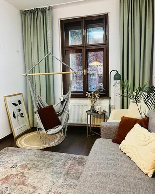 a living room with a hammock in a room at Quiet and Cozy Apartment by the Walls of Vyšehrad in Prague