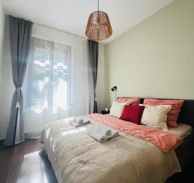 a bedroom with a large bed with towels on it at Quiet and Cozy Apartment by the Walls of Vyšehrad in Prague
