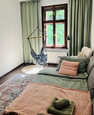 a bedroom with a hammock in the middle of the room at Quiet and Cozy Apartment by the Walls of Vyšehrad in Prague