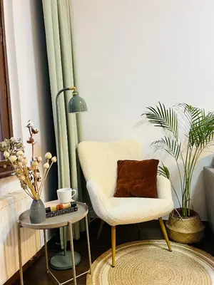 a living room with a chair and a table at Quiet and Cozy Apartment by the Walls of Vyšehrad in Prague