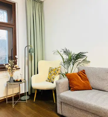 a living room with a couch and a chair at Quiet and Cozy Apartment by the Walls of Vyšehrad in Prague