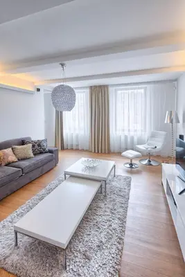 a living room with a couch and a table at Central Prague Residence Karlín in Prague