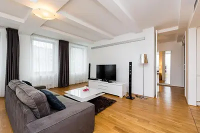 a living room with a couch and a flat screen tv at Central Prague Residence Karlín in Prague