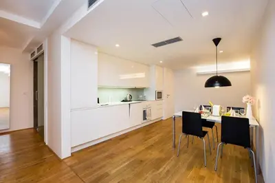 a kitchen and dining room with a table and chairs at Central Prague Residence Karlín in Prague