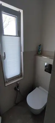 a bathroom with a white toilet and a window at Country home Chez Nous U nas in Tetín
