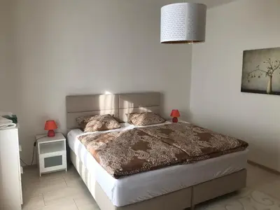 a bedroom with a bed and a lamp on a night stand at Country home Chez Nous U nas in Tetín