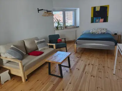 a bedroom with a bed and a wooden floor at Ubytování Na Pěšině - Private Parking in Prague