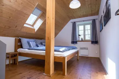 a bedroom with a bed in a attic at Roubenka pod hradem Kokořín in Kaninský Dŭl