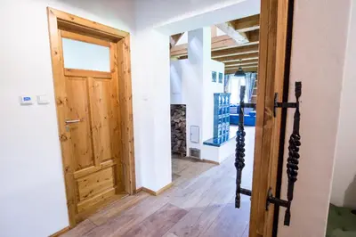 a room with a wooden door and a hallway at Roubenka pod hradem Kokořín in Kaninský Dŭl