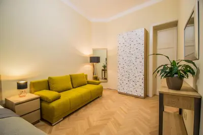 a living room with a yellow couch in a room at Royal Apartment with Sauna and Billiards in Prague