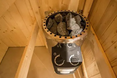 a garbage can with rocks in it sitting on the floor at Royal Apartment with Sauna and Billiards in Prague