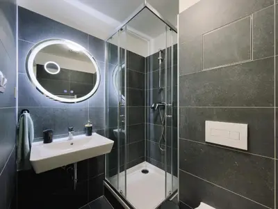 a bathroom with a sink and a shower at Studio apartments Kubanske in Prague
