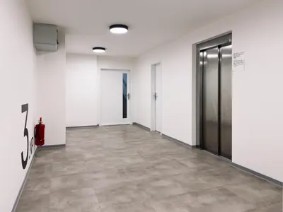 an empty hallway with white walls and a door at Studio apartments Kubanske in Prague