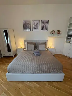 a bedroom with a large bed with two night stands at Cozy Flat in the Heart of Prague in Prague