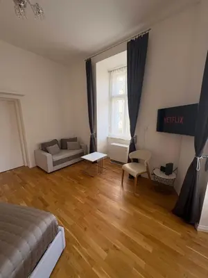 a living room with a bed and a couch at Cozy Flat in the Heart of Prague in Prague