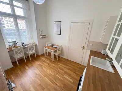 a living room with a table and chairs in it at Cozy Flat in the Heart of Prague in Prague