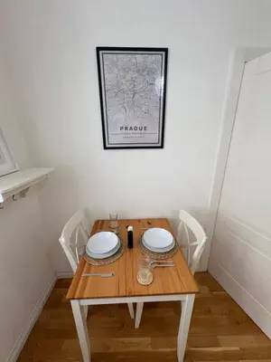 a table with two plates on it in a room at Cozy Flat in the Heart of Prague in Prague