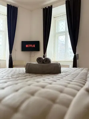 a bedroom with a bed with ametix sign on the wall at Cozy Flat in the Heart of Prague in Prague