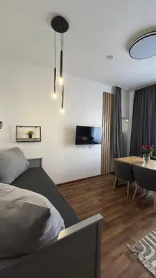 a bedroom with a bed and a dining room at VilaVala in Nymburk