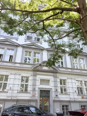 a white building with a car parked in front of it at Museum Park Apartment in Prague