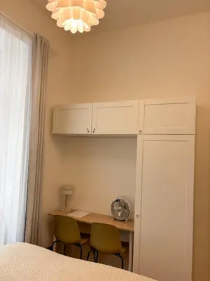 a bedroom with a desk with two chairs and a bed at Museum Park Apartment in Prague