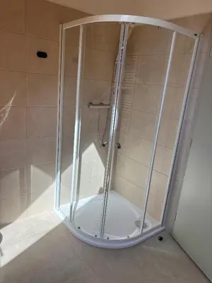 a shower with a glass enclosure in a bathroom at Apartmány Hrachov in Svatý Jan