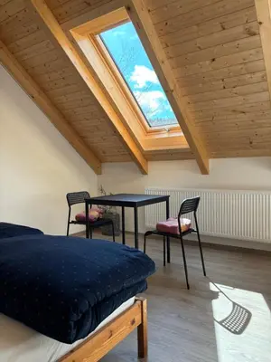 a room with a bed and a table and chairs at Apartmány Hrachov in Svatý Jan