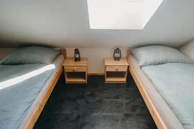 two beds in a room with two night stands at Zážitkový Ranč Nevada in Velká Lečice