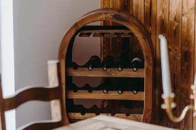a wooden wine rack with wine bottles in it at Zážitkový Ranč Nevada in Velká Lečice