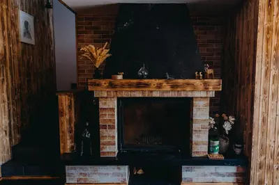 a living room with a brick fireplace at Zážitkový Ranč Nevada in Velká Lečice