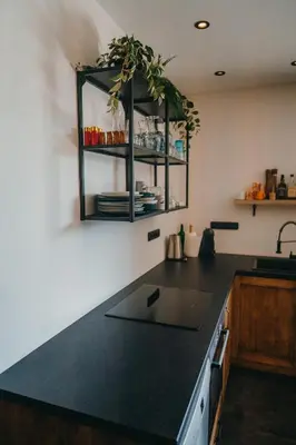 a kitchen with a black counter top in a room at Zážitkový Ranč Nevada in Velká Lečice