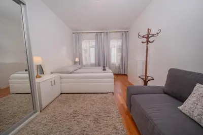 a living room with a couch and a mirror at 4 Bob's Apartments - 3 bedrooms, King size beds in Prague