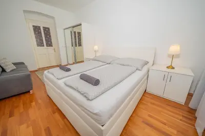 a small kitchen with white cabinets and a sink at 4 Bob's Apartments - 3 bedrooms, King size beds in Prague