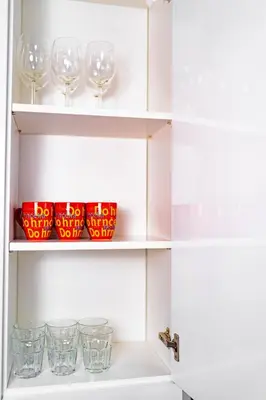 a white cabinet with wine glasses on it at 5 Bob's Apartment - 2 bedrooms with King Size beds in Prague